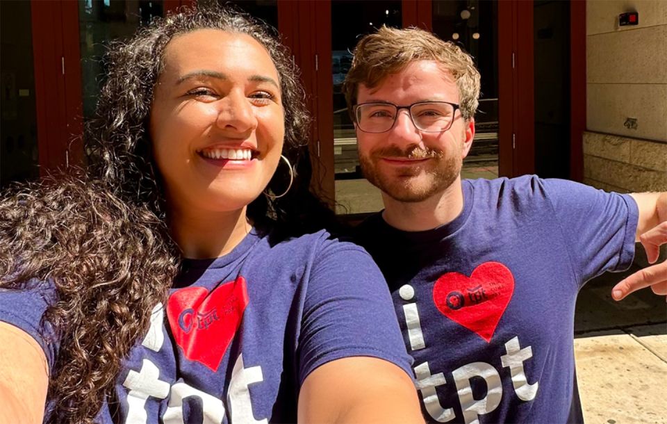 a woman and a man smiling both wearing t-shirts that say I love TPT